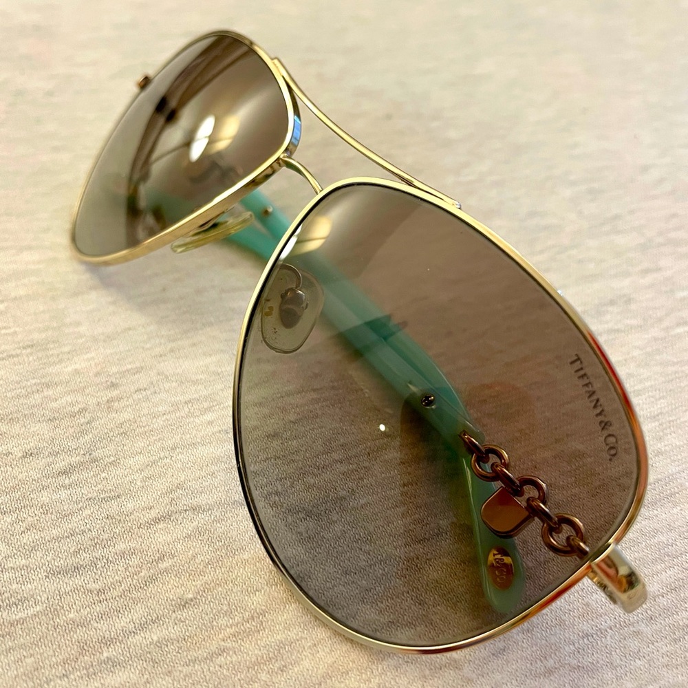 Tiffany & Co. sunglasses with blue arms and gold lock detail; with dust bag